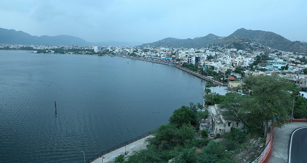 Close view of the arched marble Baradari pavilion beside the calm water of Ana Sagar Lake, Ajmer, Rajasthan
